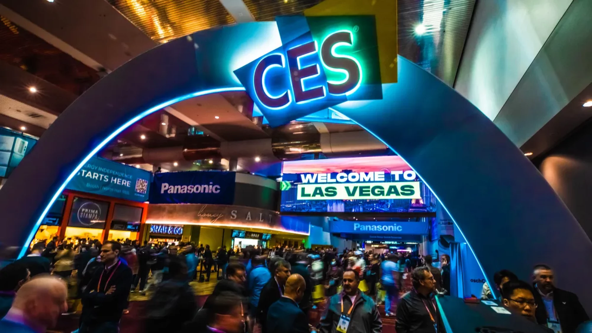 Image of CES conference logo and arch with people below it.